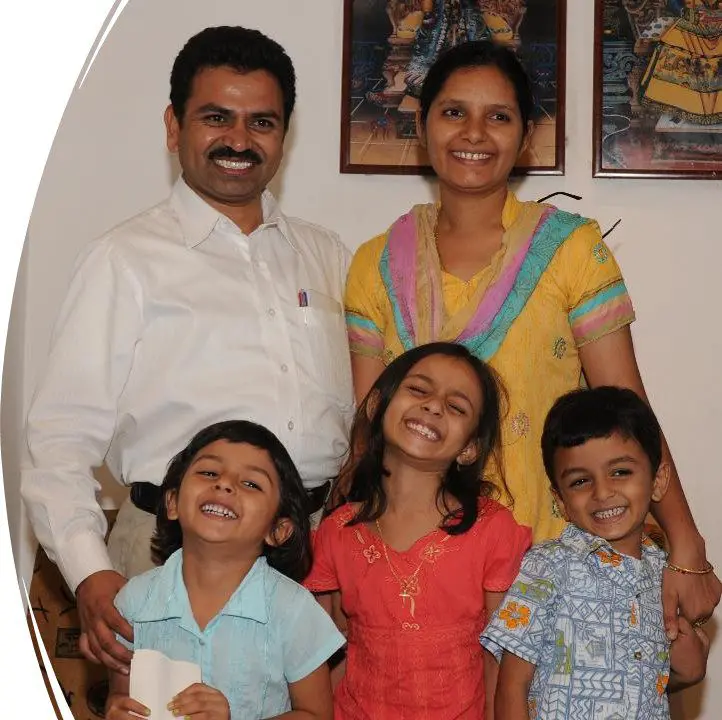 A family posing for the camera in their home.