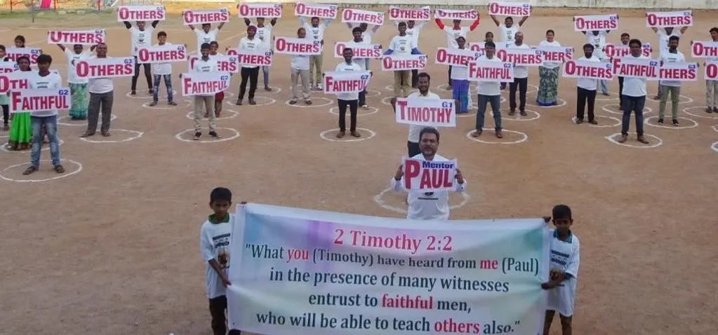 A group of people holding signs in front of each other.