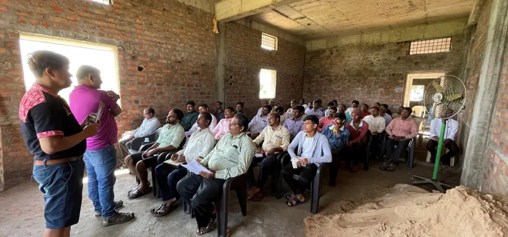 A group of people sitting in chairs inside a building.