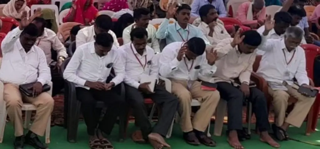 A group of men sitting on top of chairs.