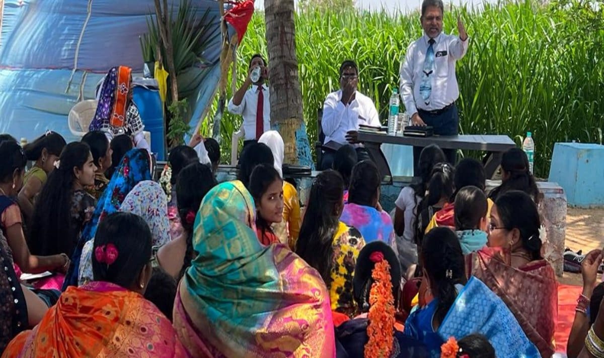 A group of people gathered in front of a microphone.