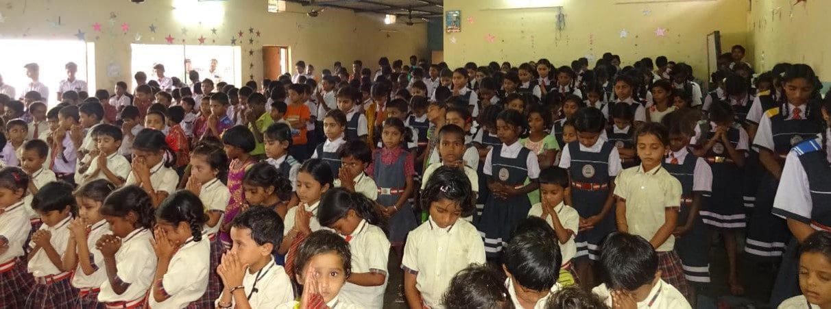 A group of children sitting in front of each other.