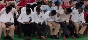 A group of people sitting on top of a bench.