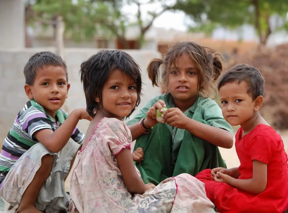 A group of children sitting next to each other.