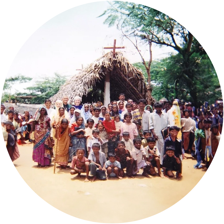 A group of people gathered around a cross.