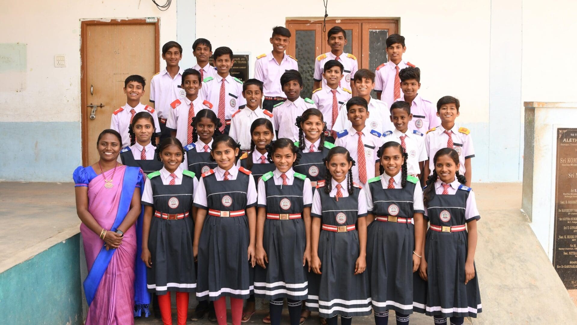 A group of students in school uniforms posing for a picture.