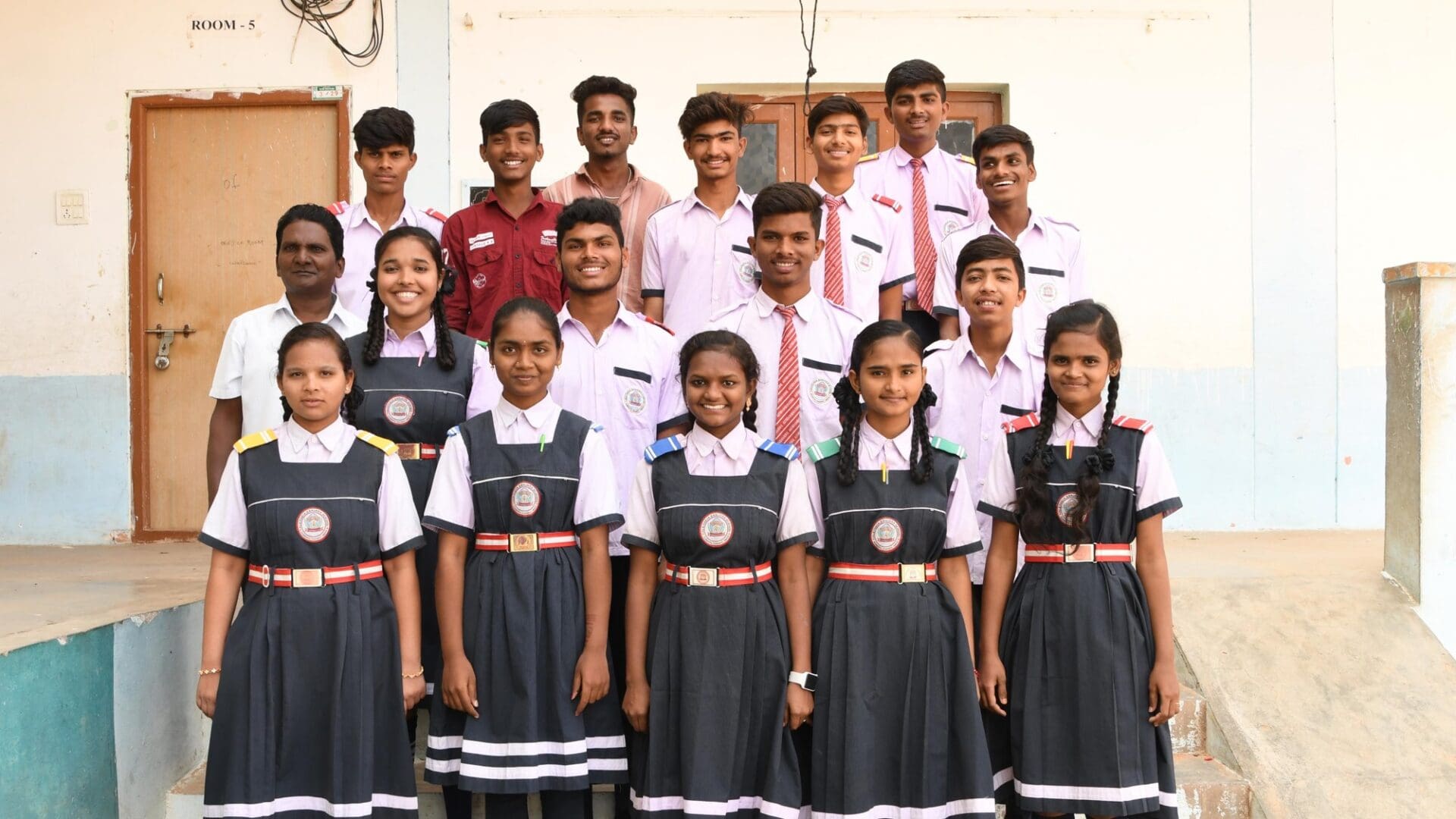 A group of students in school uniforms posing for the camera.