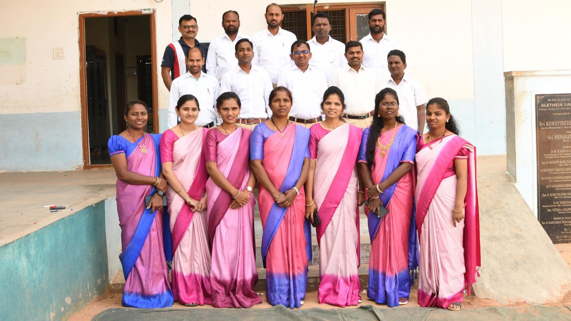 A group of people in different colored sarees.