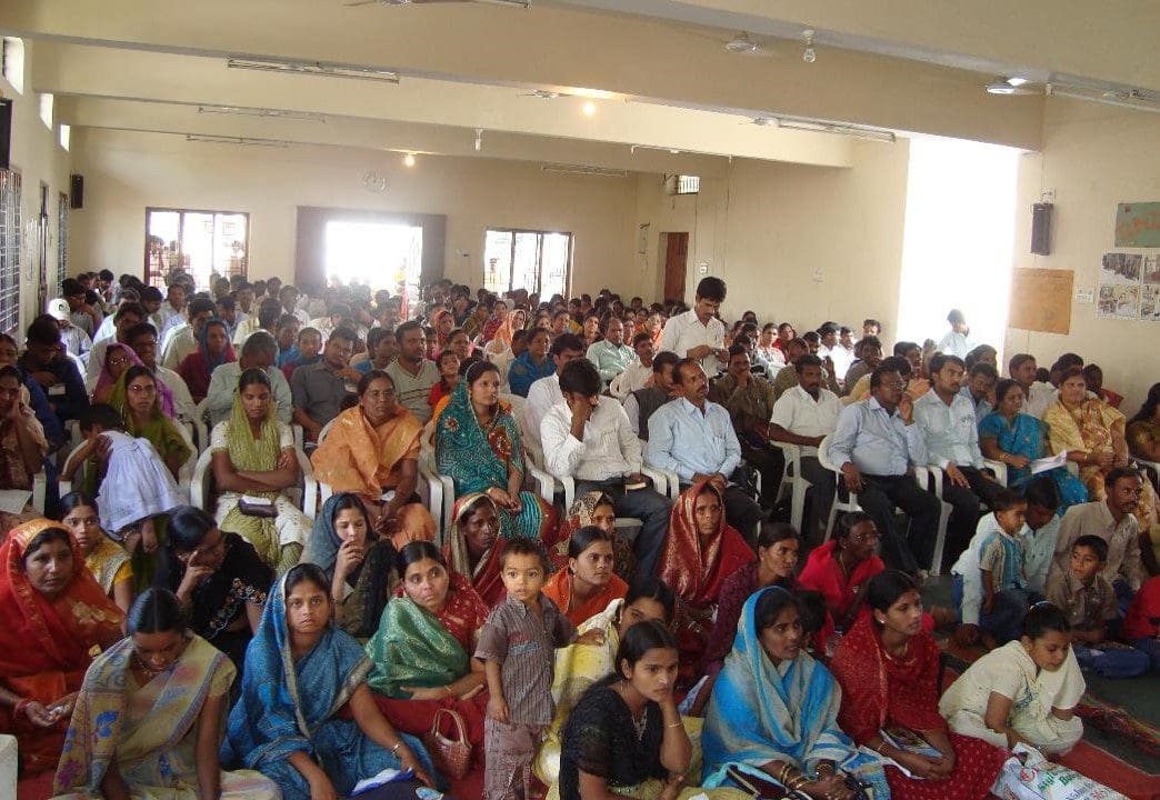 A large group of people sitting in a room.