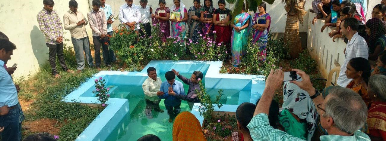 A group of people gathered around in an outdoor area.