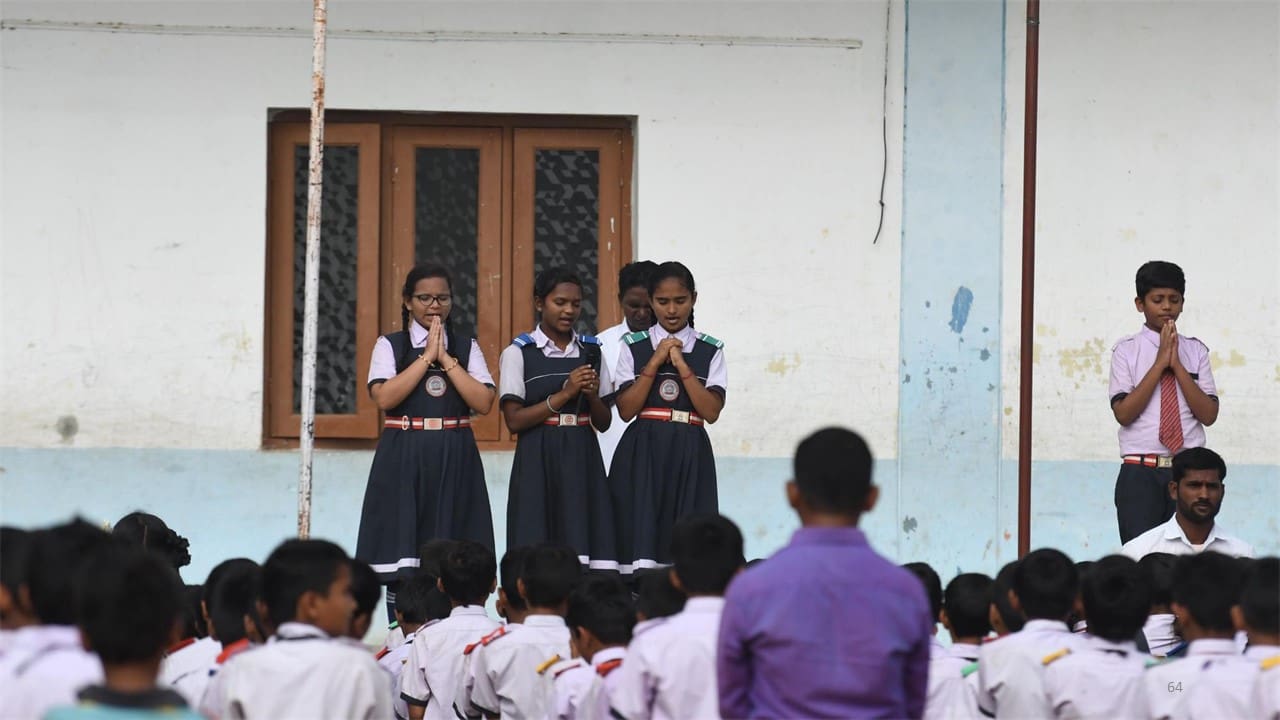 A group of young girls standing in front of a crowd.