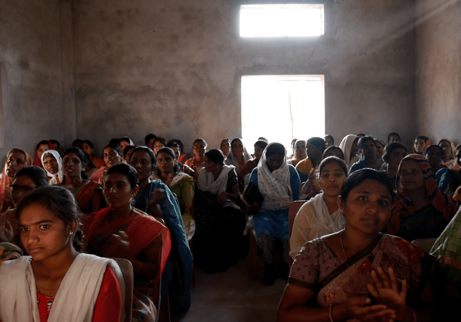 A group of people sitting in a room.