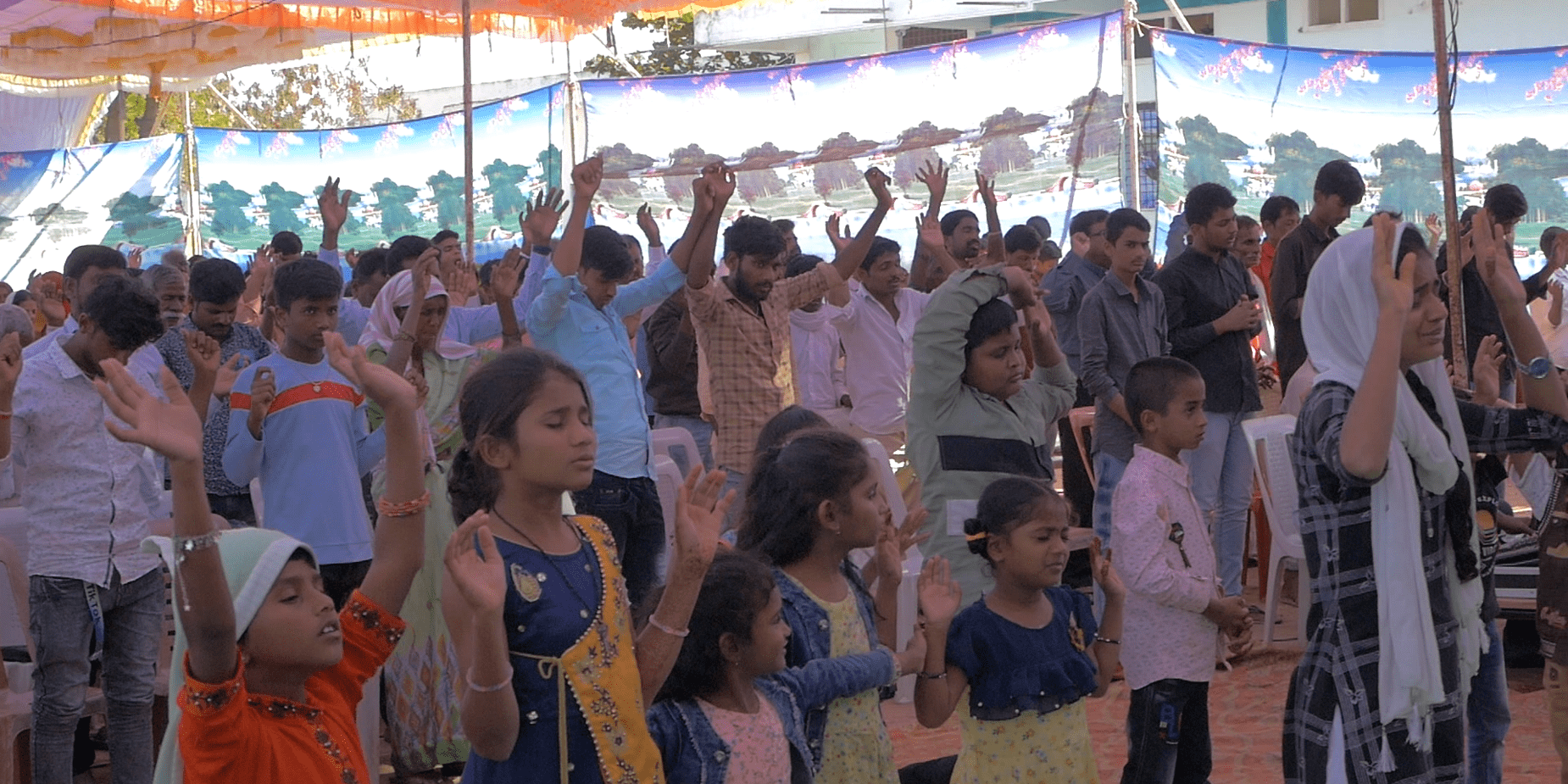 A group of people standing in front of a crowd.