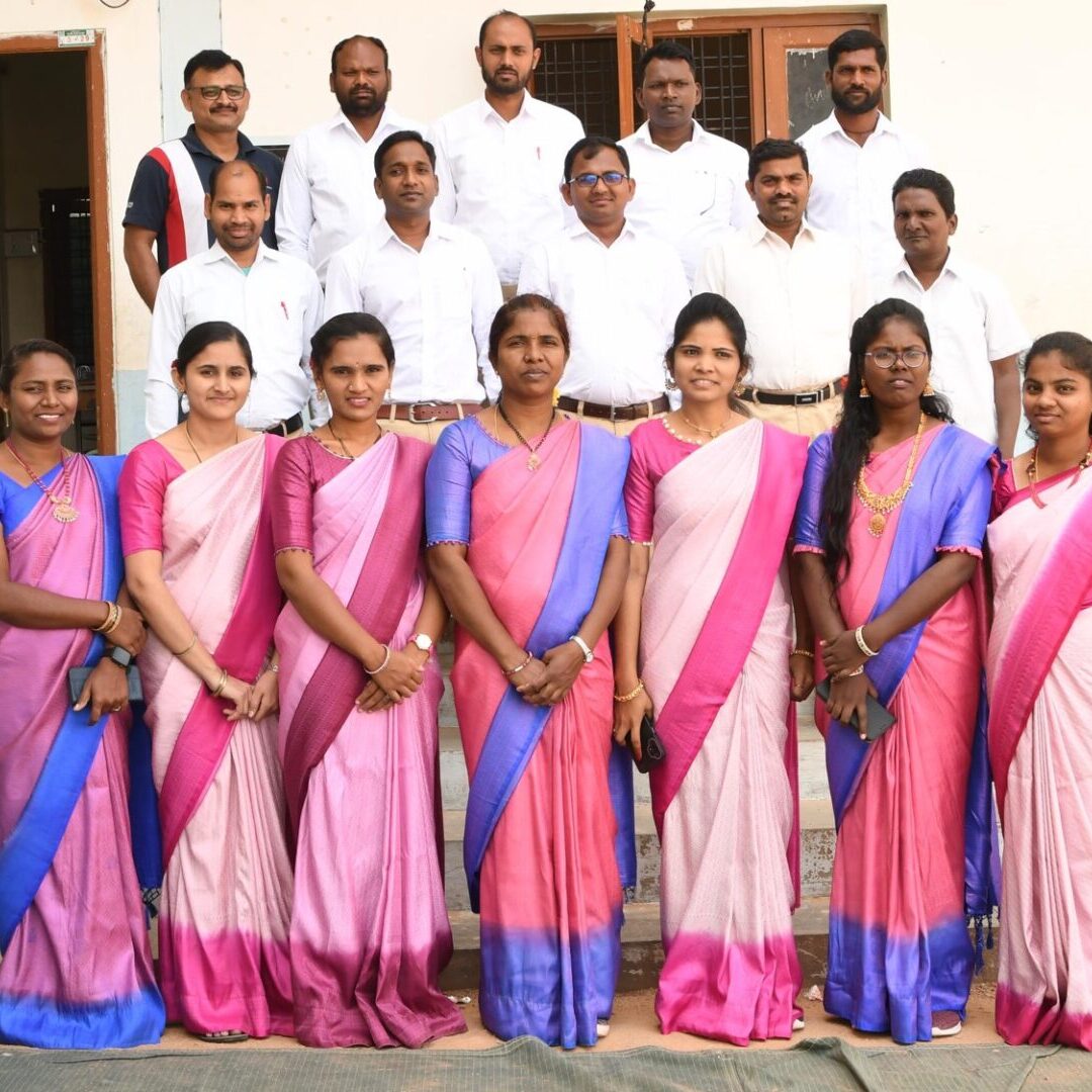 A group of people in different colored sarees.